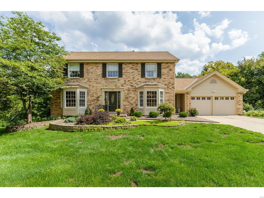 Outstanding home in the heart of Wildwood! This 4 BD, 3.5 BA, 2 story sits on a cul de sac & has gorgeous views w/heavy trees surrounding the entire rear yard. This spectacular setting offers privacy from an open deck, screened porch, deck w/sunken hot tub & patio at the walk out. There is wonderful curb appeal w/a brick façade, vinyl siding, leaded glass front door/sidelights, arch shingles, prof landscape & beautiful gardens. Features inc hardwood Entry, bay windows, cust plantation shutters, window wall in the Fam Rm, Andersen windows, B/I bookcases, W/B FP, granite c-tops, ceramic tile b-splash, st steel appl, Bosch D/W, ceramic tile flrs in the Kit-Brkfst-Pwdr-Lndry-Baths, frml DR, vltd clng in the Mstr Bdr & Bath, large W/I closet, updated Mstr Bath w/dbl bowl vanities, soaking tub-sep shower, large bdrms & more. The finished, W/O LL adds app 698 s/f for a total of 3,134 s/f of finished living space. Top rated Rockwood schools, an outstanding home, spectacular setting…a must see!