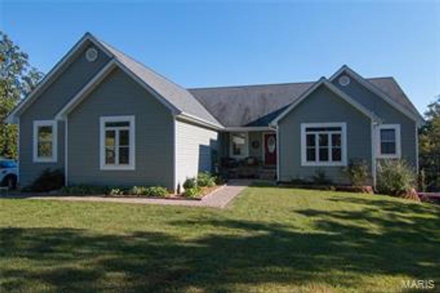 This beautiful five bedroom, three bath home on 5 acres is above and beyond your expectations and dreams.  It has a full living quarters on the lower level including a separate drive and entrance.  The underground sprinkling system makes the lovely landscaping easy to manage.  Watch the wildlife from the large deck or watch the kids play on the Rainbow play set or the concrete basketball court.
Save on utility bills with the heat pump as well as the outside wood furnace.  A large, economical home, what more can a person ask for.