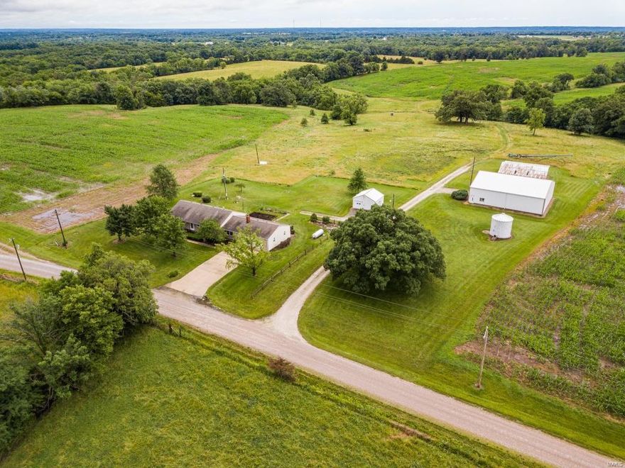 This Picture-Perfect Ralls County 159-acre m/l row crop farm includes a 3 bedroom/3 bath, 2,600 sq ft home.  Located just 5 minutes from New London and 15 minutes from Hannibal, this property is the best of both worlds with peaceful country-living and all amenities just a short drive away.  The home features 3 bedrooms on the main level, an eat-in kitchen, formal dining and two large living/family rooms.  Downstairs is an additional living area and laundry room.  The back patio looks out over the beautiful rolling land.  116 of the 159 acres are tillable and 20 acres are in CRP for additional income!  The wooded draws offer great hunting areas making this a true combo property. Outbuildings include a 54 x 60 Morton building with a concrete floor, a 40 x 60 open shed and an additional 20 x 20 garage/storage shed.  This property is a must see!