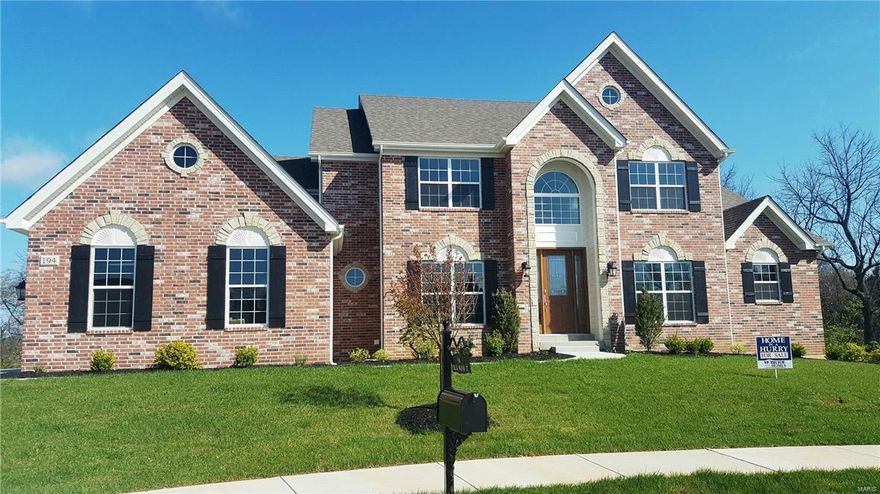 NEW HOME IN A HURRY! Stately American Colonial Brick and Stone on a great cul-de-sac homesite. Open floor plan, 4  Bedrooms and Bonus Rm (or a 5th bedroom), Dramatic 2 story Great Room and Foyer. Luxury Gourmet Kitchen w/ Stainless Steel Appliances and Granite Countertops, Custom Cabinets w/ soft close drawers, Butler Pantry, 9' first floor ceilings, 8" first floor doors, Crown Moulding, Bay windows at the kitchen and Master Bedroom, Coffered ceiling in Master Bedroom, Dinning Room tray ceiling, Chair rail and wainscoting at dining room, Stained Glass 8' front door, Spacious Master Bathroom, 3 car side - entry garage, concrete patio off walk-out. Approximately 3/4 acre homesite backing to woods!