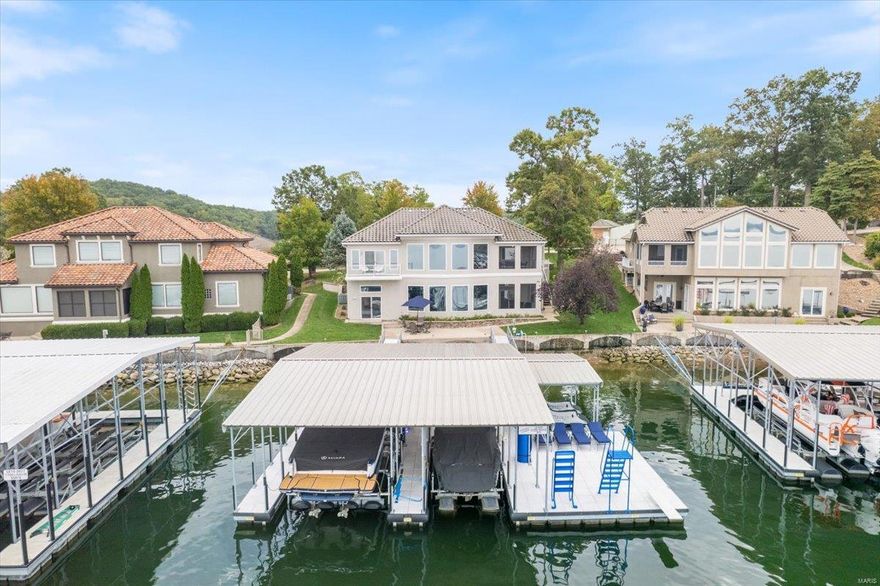 Lakefront Living at its finest. Coveted 10-Home Gated Community w/community pool in Molokai Pointe Estates in Sunrise Beach, MO on MM10! This 4-bed, 4.5 bath home is the Epitome of Luxury & Class! Features: Billionaire Views of the Main Channel thru a 25' wide wall of floor to ceiling windows, 12’ ceilings, 3-car garage, Flat driveway, Open floor plan, Chef’s dream kitchen w/ granite countertops, huge bar level island, +60" fridge/freezer, walk-in pantry, 2 walk-out covered patio, Main level master suite w/steam shower, large walk-in closet w/laundry, & private deck w/lake views, wet bar w/ice maker & kegerator, game room & family room, 3 more ensuite bedrooms w/ 2 having private view/private water access, laundry room. Walk-out just 15' from seawall to a double walkway onto a 3 Well dock (14x36, 10x26, 12x12) w/double pwc hoist, wet steps, high dive, & diving board. Enjoy the big main channel views & calm water thanks to a community breakwater. Turnkey property! Additional Rooms: Sun Room