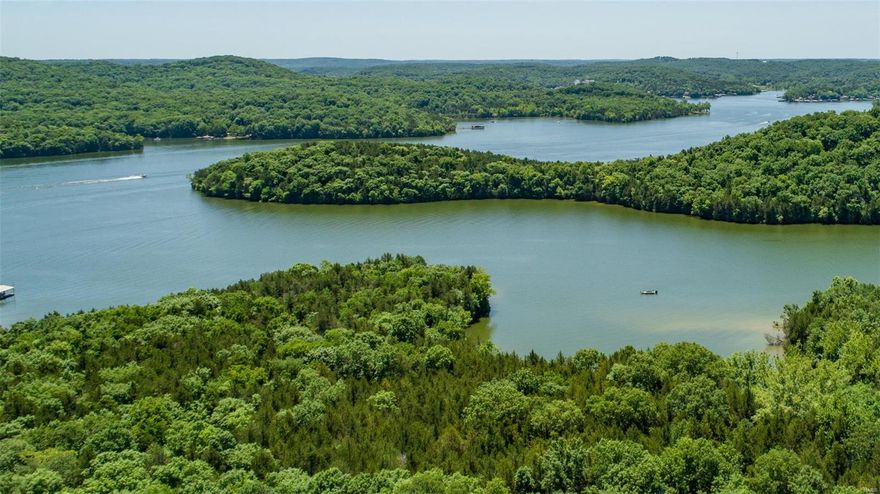 Remarkable piece of paradise nestled on the shores of Lake of the Ozarks. Encompassing 134.52 surveyed acres of land, this large lake property has 2,370 feet of dockable lake frontage in a quiet cove, making it ideal for your lakefront estate. The massive span of land has a blank canvas, ready for your visions. This property presents many choices for potential build sites. Whether you envision a secluded retreat nestled in the timber or an expansive estate commanding the water's edge, the options are as boundless as your imagination. Rarely does a property of this quality and size come to market, making it an exceptional investment opportunity for those who recognize the value of owning a piece of Lake of the Ozarks shoreline paradise. Take advantage of this chance to own a truly distinctive piece of real estate with massive potential. With its gradual lake frontage, breathtaking views, optimal positioning and great road frontage, its an opportunity you will not want to miss.
