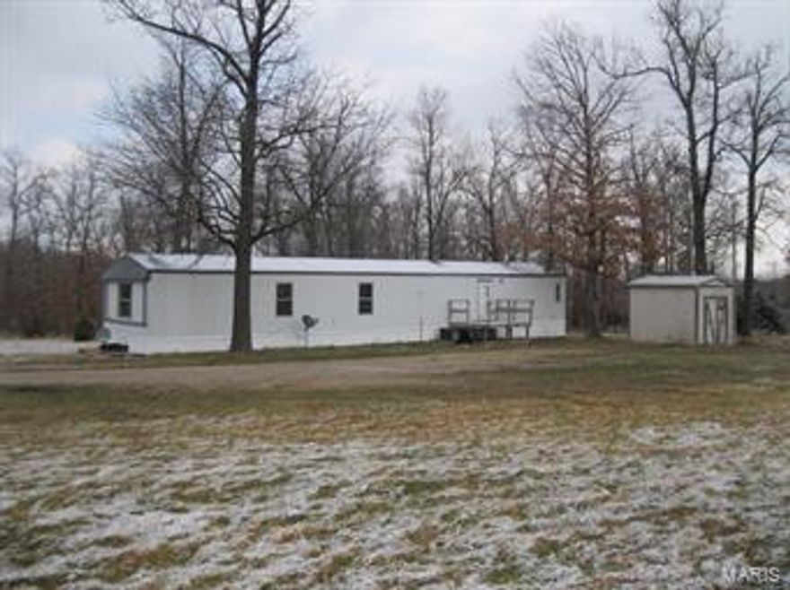 Land is gently rolling. Very nice fenced yard for cattle or horses. Very private. Sits aways off county road. Mature trees in yard. Nice small building for storage. Trailer needs remolded. Property to be sold where is as is. Has it's own well.