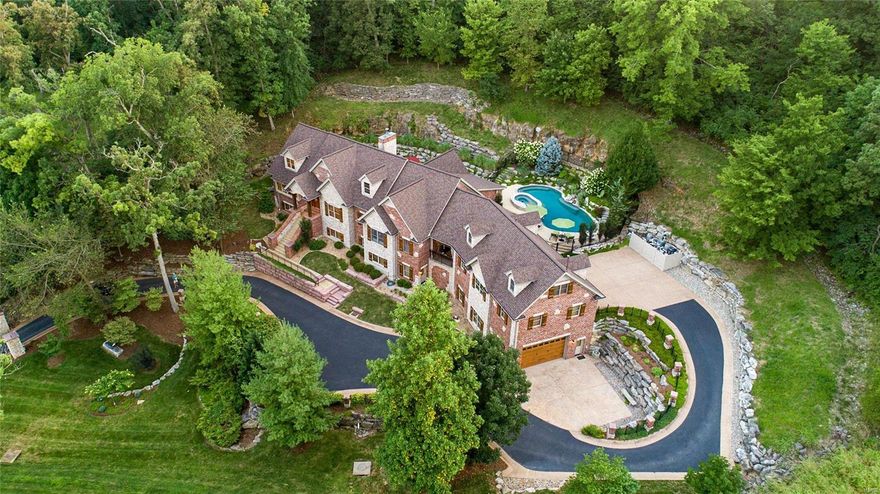 Amidst a sea of traditional properties, this home defies convention! The perfect fusion of an inviting Colorado lodge & a peaceful spa  resort, this home will envelop you with its' sophisticated yet relaxed warmth. Impeccable details at every turn w/ over $530K of extensive improvements, including an award-winning in-ground pool/hot tub & show-stopper outdoor kitchen-perfect for family gatherings or grand entertaining! With over 6700 sq.ft. of finished living space, you'll be wowed by the huge great rm w/ striking vaulted wood ceilings, custom built-ins & exquisite stone frplc. The chef's delight kitchen has all the bells & whistles & overlooks a cozy sitting rm filled w/ natural light. 5 spacious bdrms plus a studio apartment above 1 of the 7 garage spaces. Fabulous finished LL provides additional space for fun or relaxation-pool table included! Perfectly situated on a prime cul-de-sac location, this magnificent all stone & brick residence will captivate you at the curb! A must see! Additional Rooms: Wine Cellar