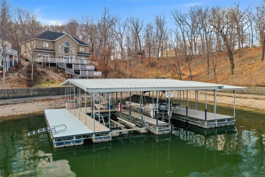 WOW! That's what you'll think when you walk in the front door and look over the great room to a view of your dock and the lake. 24' vaulted ceiling with windows from floor to ceiling and a gas fireplace. Just across from Margaritaville at the 26 MM of Lake of the Ozarks. This beautiful 5 bedroom 3.5 bath Lake home has a three well dock, (largest slip 12'x40'), 3 lifts stay, for your boats and PWC's.  Room for entertaining, or sunning, on both sides of this 52'x44' dock,. Blacktop to the home and concrete parking in front of your three car garage. One bay is 25' deep for storage of Your extended vehicle, a boat, or a great place for a hobby bench. Huge master bedroom with coffered and back lit ceiling as well as a large master bathroom  w/large walk in closet. Bathroom has  double sink vanity, a jetted soaking tub, large step in shower and a water closet. Dining and Kitchen is well lit from the large window area over looking the decks and the lake. Call me for your private showing.