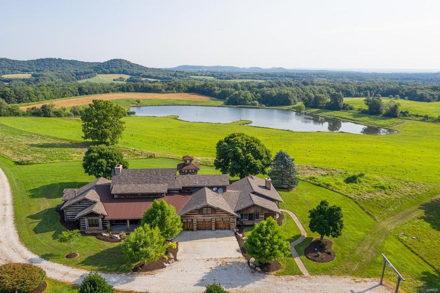 MONTANA IN MISSOURI “Where Old World Rustic Charm meets Modern Luxury” - Gobbler’s Roost Farm is a diverse wildlife paradise comprised of 290 acres.  Situated at the base of a wooded knoll, the property is a significantly large tract for the area and is just a short 1-hour drive from St. Louis Lambert International Airport. This “Montana” style Luxury Log Home was meticulously designed to emulate the grand lodges of yesteryear.  Craftsmanship is evident throughout the home.  Hand hewn logs and timber trusses are joined with European dovetail and wooden pegs.  Corten roofing material, IPE walkways and cedar posts provide rustic charm while maintaining modern strength and durability. A three-story watchtower looks out over a 5-acre lake and into the distant hills and valleys. Listing Supplement document for FULL property description Additional Rooms: Mud Room