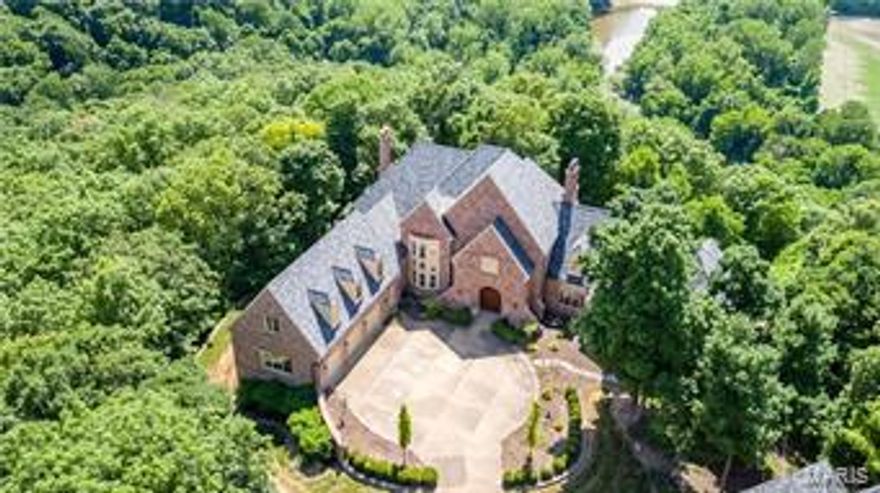 Remarkable estate w/outstanding $400,000 price adjustment, along w/fresh paint, wallpaper & outdated window treatments removed. Beautifully staged & seller is eager for a contract! Located on a Bluff lot on the gated Wings Rd within St. Albans Country Club w/amazing views for miles. The main house is a 1.5 sty with 4+beds & 6 full/2 half baths, finished walk out lower level yard w/lovely in ground pool. 2-story great room, paneled library, huge kitchen/hearth room, dream master suite w/sitting area, his & her customized closets & glamour bath. Upstairs 3 large beds each w/own bath plus  2nd floor family rm. The LL has a lge family rm w/lge customized wet bar w/built ins, 2nd kitchen, media rm & possible additionaled rs w/full bath. The detached carriage house w/ 2nd-flr guest quarters w/family room, bedroom, full bath & kitchen area. (Bath & kitchen have to be finished out but all the plumbing is in. New windows & roof recently installed. Simply breathtaking.