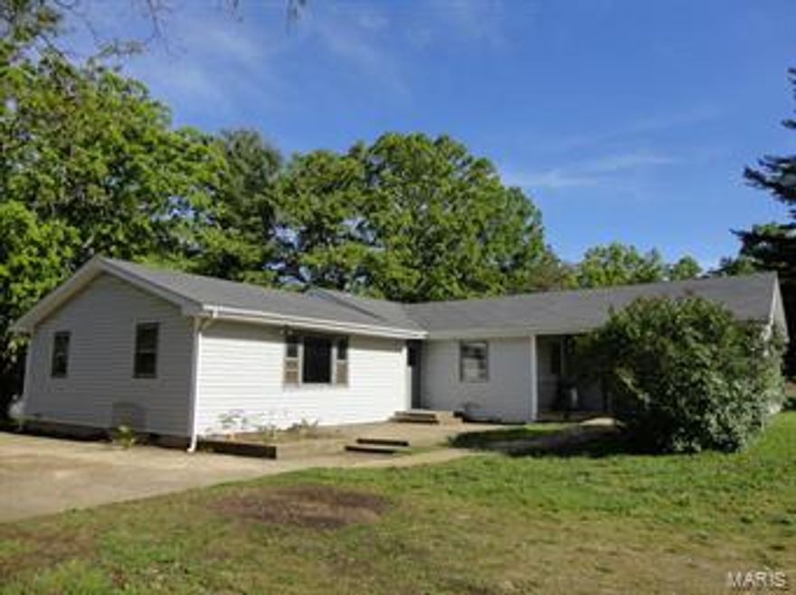 PRICE REDUCED!!!! 3 Bedroom, 3 Bath home only minutes from town! This perfect starter home is priced to sell quickly. Many updated features including a new propane furnace in January of 2015, new carpet in 2013, newer pressure tank, and a newly remolded bathroom in 2013. Extra large hallways and a bedroom that is wheel chair accessible. Your option of two master bedrooms, both with their own bathrooms. Large closets through-out the home for lots of storage. Partial basement and main level laundry area.  30' X 24' barn with chicken coop and a horse stall. 65' X 24' detached garage with electric and concrete floors.  Property is being sold AS IS. Great location in the R-80 school district!