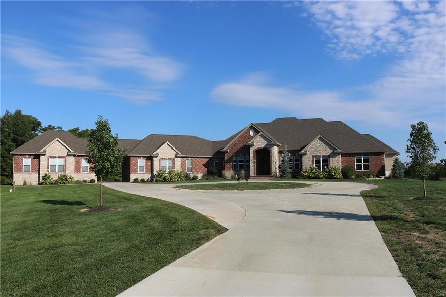 Luxury resort style living on 14+ private acres in St. Charles County! Endless outdoor amenities; ATV trails, heated & cooled 70,000 gallon salt water infinity pool w/ jumping rocks, waterfall, slide, grotto & cool decking, hot tub, putting green, covered outdoor kitchen, brick & stone wood FP w/ pergola or cozy up by the fire & ice FP poolside. Over 6,400 sqft of living space, this unique custom ranch is complete w/ 6 beds, 3.5 baths. Chef's kitchen offers Wolf gas top, stone hood, granite butterfly bar, center island & built in KitchenAid fridge & adjoining hearth room. Master ste complete w/ Spa-like bathroom, heated floors, dual entry steam shower, dual vanities, jetted soaker tub, & lrg w/i closet w/ prep area. Finished walkout LL w/ 10" pour, rec room, hi-tech theater rm, music studio, game room, wet bar, 3 guest beds, safe room & full bath. Dual zoned HI-E geothermal HVAC. 5 car rear entry garage w/ breezeway &  60' x 40' barn w/ power. Wentzville schools & close to shopping. Suitable for Bed/Brk