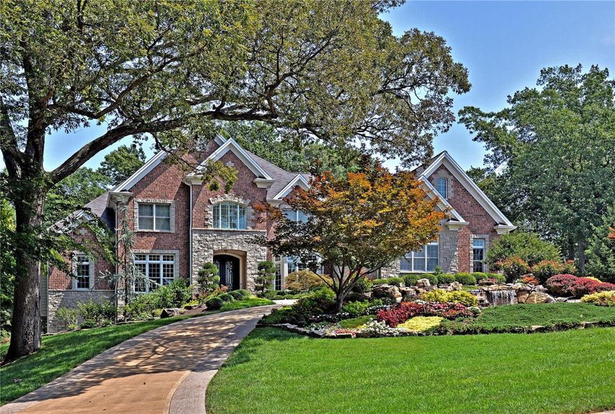EXQUISITE 8,200+ SF 1.5 STY COMMANDS Attention to EVERY Possible DETAIL! SHOWS LIKE A DISPLAY! STUNNING VIEW of the BACKYRD Setting As you Enter the Dramatic 20' High Foyer Leading to Great Room w/12' Beam/Paneled Ceiling!  MASTER SUITE is a SERENE OASIS w/GORGEOUS 6 Window, Floor to Ceiling Bay Overlooking Backyard Waterfall & Wooded Setting! CUSTOM Bath Includes Heated Floors, Jetted Tub, Double Headed Shower w/Body Jets & More! Gourmet Kitchen Offers Granite, Viking Stainless & Cherry Paneled Appliances PLUS Sub Zero Paneled Refrigerator! Floor to Ceiling Stone Fireplace in Vaulted Hearth Rm. Library w/Custom Details. 3 Large Bedrms, Private Baths, Balcony, Loft & Laundry Complete the 2nd Floor! 7 Seat Theatre, Game & Family Rms PLUS 5th Bedrm & Full Bath in Walk-Out LL. GORGEOUS, PROFESSIONALLY LANDSCAPED .98 Acre Lot Backing to QUEENY PARK (Private Access) Includes 2 Stunning, Stone Waterfalls! OUTSTANDING Curb Appeal with Circular Drive! EXCELLENT Location; Minutes to Hwy Access!