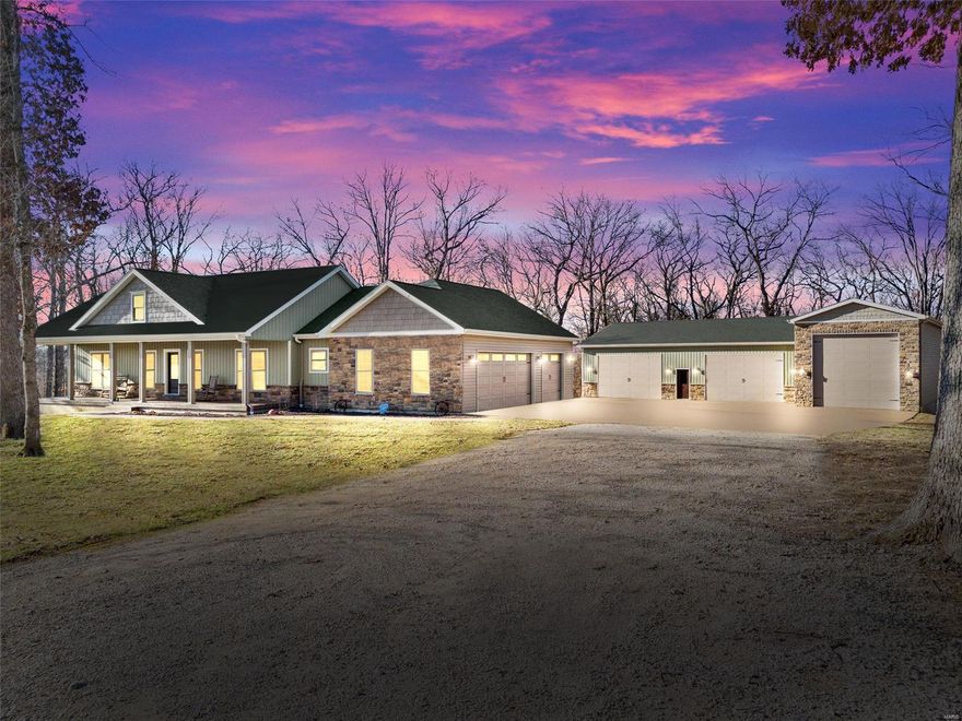 Pride of ownership is evident in this impeccably maintained custom 1865 SQ FT home, nestled in a quiet subdivision on 3.7 wooded acres. The custom kitchen has quartz counters & 42 inch staggered cabinets, stainless appliances & large center island w/ breakfast bar. The great room has stacked crown molding & a stone ventless gas fireplace plus beautiful hardwood floors. The unfinished basement has a rough in for full bath & a walkout. Master bedroom & kitchen both open onto a 32 x24 exposed aggregate patio with built in fire pit, a perfect place to spend your summer evenings. There is a 2,800 SQ FT detached garage that has a 20'x50' area with 16' walls & a 14'x14' overhead door, ideal for RV or boat storage & a heated 50'x36' area with 12' walls & two 16'x10' overhead doors. Spend your mornings drinking coffee on the covered 49'x8' front porch & you will find that living here is like being on vacation all the time. This home has too many features to mention, schedule your showing today!