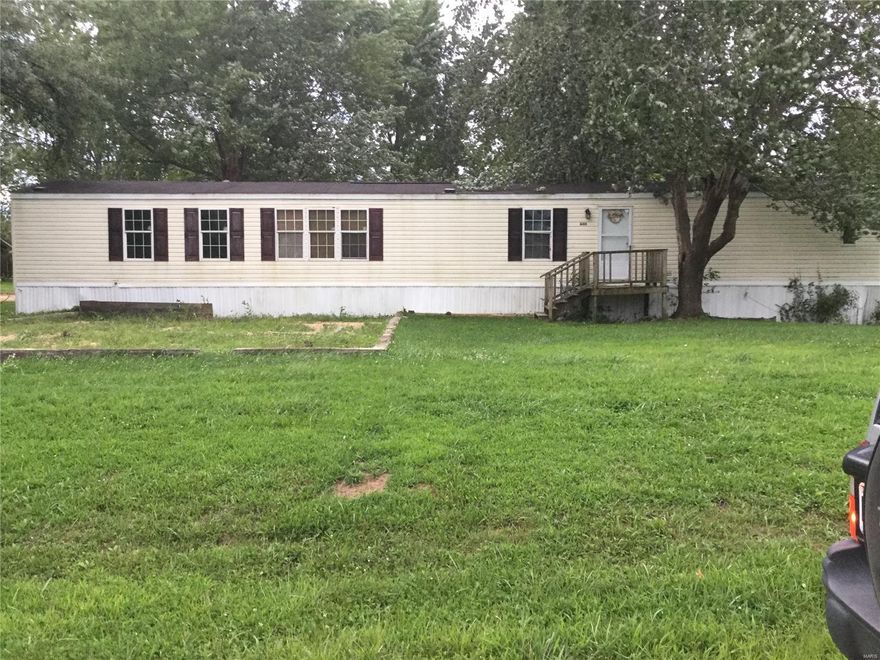 Price REDUCED!!!  2006 16 X 80 mobile home on 3 city lots totaling 0.63 acres.  3 bedrooms and 2 bathrooms, kitchen, dining room, living room and utility room.  Small wooden porch on front and wooden steps on back.  18 X 24 detached garage/workshop with concrete floor and electric ran to the building.  City water and sewer.