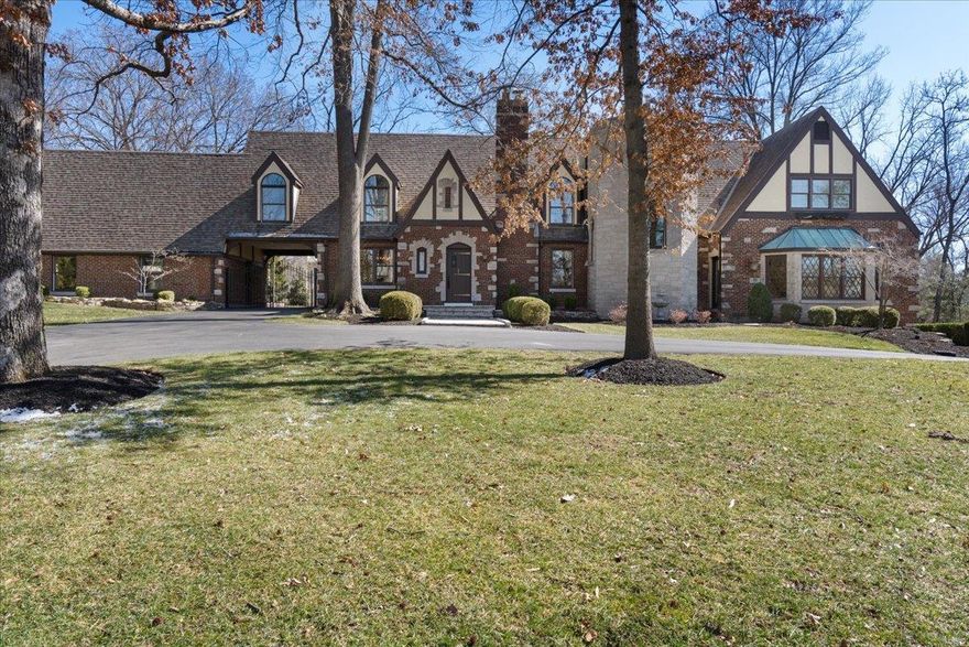 This beautifully renovated estate-like English Tudor styled home is situated on over an acre lot, surrounded by mature trees with a private, park-like setting in prestigious Frontenac, MO. The residence has been updated with modern amenities and has approximately 7700 sq ft of living space consisting of 4 bedrooms, 4 full baths and 2 half baths, eat in kitchen that opens to an expansive composite private deck, gym, quarter sawn hardwood floors throughout, abundant storage, large rooms with lots of natural light that enhances all the detail design. The renovated kitchen is a chef's dream with custom cabinetry, Sub-Zero and Wolf appliances and Quartzite countertops. There are 2 separate garages for a total of 5 spaces. Updates include kitchen, primary bedroom and bath, den with wet bar and ceiling to floor custom bookcases, windows, gym, professional landscaping, security system, sprinkler system, plumbing, stone front walkway, Seller to provide 1 year homeowner warranty. Ladue schools!