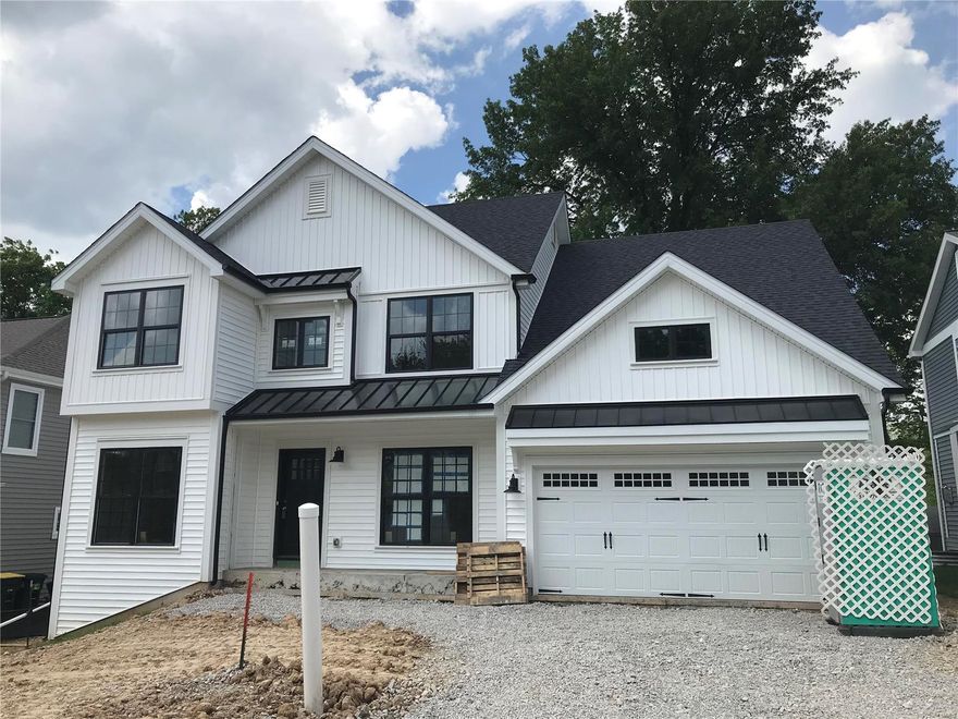 New custom 2-story home under construction by Prestige Custom Homes in Kirkwood.    This 5 bedroom, 4.5 bath home joins 2 other new homes in a row on N. Woodlawn and features a 2-car garage, 9' first floor ceilings, fireplace, custom cabinets with soft close drawers and doors, lazy susan, double trash pullout, crown molding, stainless steel appliances, Quartz countertops, large island, job stained hardwood flooring on first floor and 2nd floor hall, wainscot trim in dining room,  7 1/4" crown molding on 1st floor, 6 1/2" base molding, large large master bedroom with coffer ceiling and two huge walk-in closets, vaulted master  bath suite with separate tub and shower, adult height vanity, granite countertops,  bay windows, tall basement pour, finished lower level with rec room, full bath, and bedroom. Additional Rooms: Mud Room