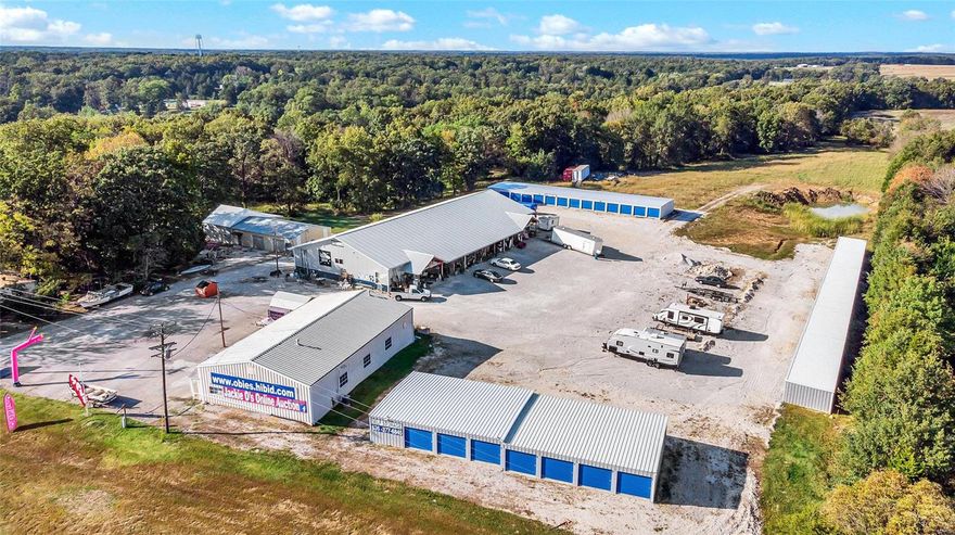 ENDLESS OPPORTUNITY RIGHT HERE!! AWESOME LOCATION!Take advantage of this High Visibility 19++ Acre property w/ a TON of improvements!Currently used as Auction House,(Jackie O's)-The 8400 sq ft, AMISH Built Building w/ Handicap bathrooms, Full kit, Office, dressing rooms, concrete flr, electric, 12' Garage dr & full HVAC!Additionally, a 70X40 Multi-purpose Commercial build.,previously a church, & then a resale store,& A 48X30 pole & metal structure unattached garage/shop building w/ 2 roll-up doors, concrete flr & electric.Lastly,(3) sets of storage units, 30X18=18units, double deep, 220X15=25 units,& 140X30!Truly, a Beautiful piece of land, approximately 1/2 woods (with pond) & 1/2 pasture land.There is a deep well, septic, & asphalt as well as gravel parking lots. Manufactured Home is on public water.  CALL listing agent for your Private showing today- LAND, Improvements, & possibly inventory is for sale- NOT the Biz itself. All leases w/ the rental units will go to the new owners. Location: High Traffic, Hwy/Interstate Frntg, Other, Rural