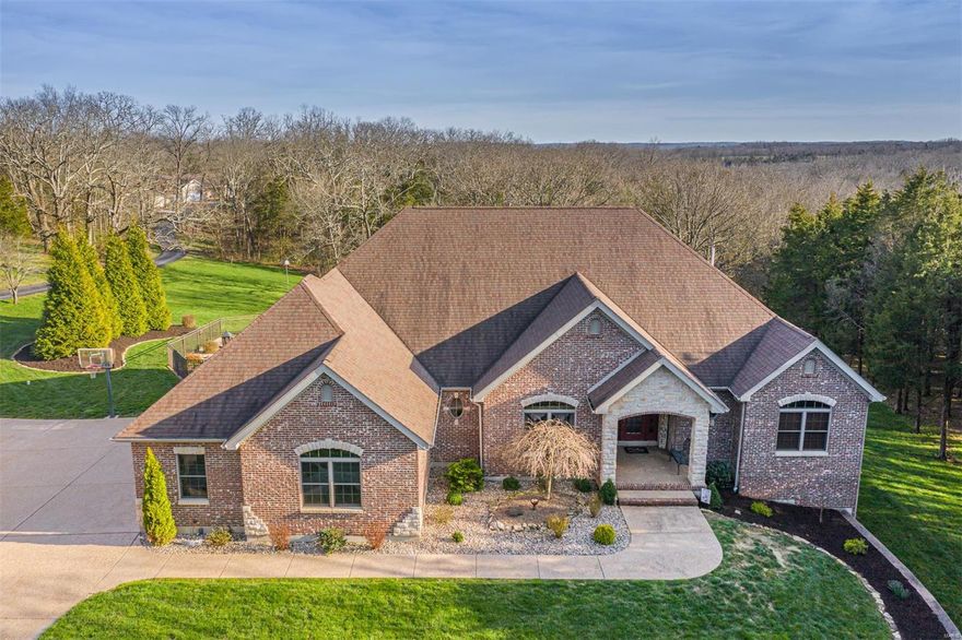 STUNNING!!  Absolutely stunning! !  This place is gorgeous, no matter the season.  Private setting for this brick and stone home nestled back in the trees on just under 5 acres. Quality is evident the minute you turn in the aggregate driveway. Big rooms, huge master suite with jet tub, separate shower, and walk-in closets.  Two other generous bedrooms have a private bath system- lots of storage and closet space.  Hearth room w/ stunning fireplace has never burned wood.  You can be the first or continue to use candles. All stainless kitchen appliances stay.   Finished lower level is top notch,  but lots of room left for storage and equipment.   Deck off hearth room overlooks big in-ground pool, completely fenced and landscaped.  Pool is 4' to 8' at deep end.  Over 1500 sq. ft. detached garage built in style/architecture of home - building is heated and has full bath.  Serious planning is evident here.     Mirrored cabinet in master bath will be replaced with mirror. Additional Rooms: Mud Room