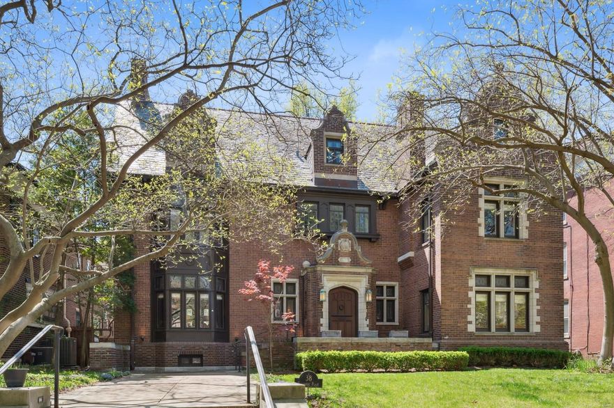 Outstanding 1908 English Tudor overlooking the parkway of historic Kingsbury Place. This tastefully-renovated home features gorgeous oak paneling, refinished oak and pine floors throughout, fantastic new kitchen and primary bedroom suite, plus a striking carriage/guest house with a ski-lodge design. Architectural details include bay windows, leaded glass, elaborate wainscot, crown moldings, plus 2005 slate roofs on the main house and carriage house. A grand entry hall leads into a rich, mahogany-paneled living room, an amazing dining room, and an inviting library/den. A fabulous new kitchen includes top-of-the-line appliances, marvelous cabinet space, and overlooks the spacious back yard with stone patios, open green space, and the stunning carriage house. The new primary bedroom suite is remarkable, with tasteful primary bath, huge walk-in dressing room closet, stacked w/dryer, and formal bedroom w fireplace. The 3rd floor is sensational, with huge family room and abundant built-ins.