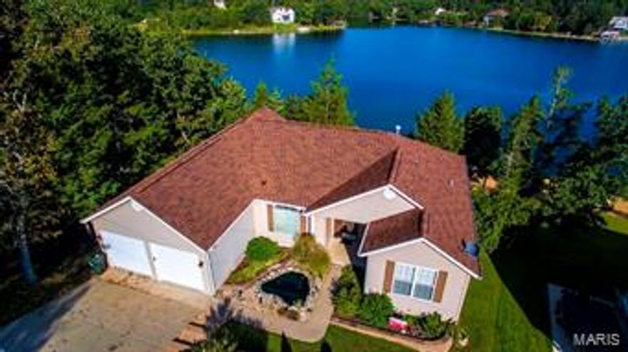 Absolutely beautiful ranch home w/ tons of updates! Feel as if you are on vacation living in this spacious home backing to the lake! This 4 bed, 3.5 bath custom built waterfront home is sure to please! Breathtaking water front views of the 53acre fishing lake welcomes you home. Stunning hardwood flooring through out the main floor & vaulted ceilings. The spacious great room features a gas fireplace w/ built in cabinets as well as convenient access to a large private deck w/ custom Sunsetter Awning. The kitchen has 42" cabinets, large pantry & stainless steel appliances. The main floor master suite offers vaulted ceiling, 2 walk in closets, private deck access, adjoining master bath w/ double vanities, large corner tub & separate shower. The finished walk out lower level offers additional living space w/ family room, wet bar featuring granite counter top & 2nd gas fireplace, additional bedroom, as well as another full bath. Outdoor fire pit, lake access, beach, golf course, pool & MORE!