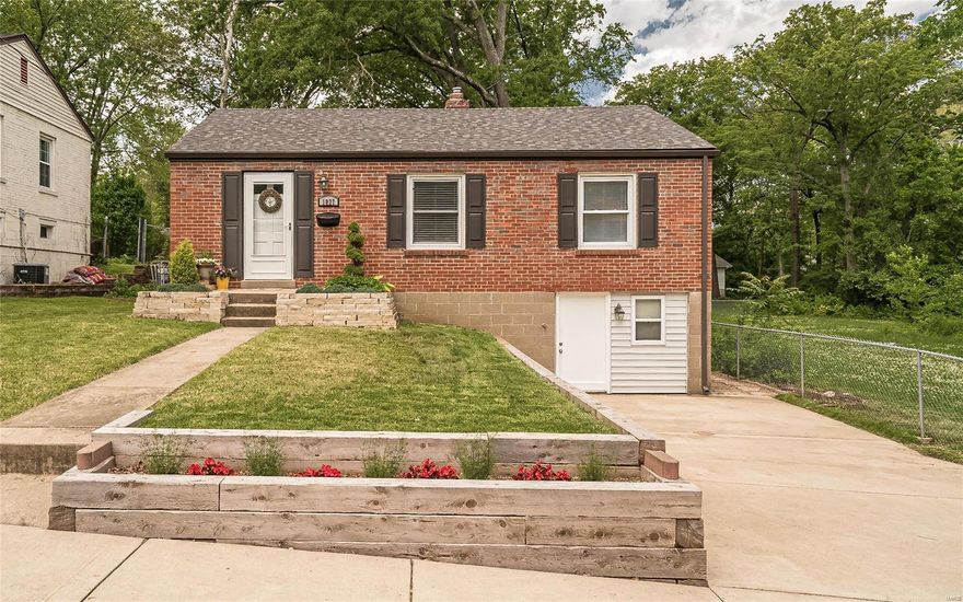 You will love this charming brick bungalow located on a deadend street adjacent to Sanders Park! This lovely home features original hardwood floors, 4" trim, updated windows & a newer roof as well as stainless steel appliances and an attractive living room and dining room + two bedrooms and an updated bathroom that boasts custom tile work! You will also enjoy the family room in the lower level. The park-like backyard features large, stately trees, a nice patio as well as over 40 plants that are native to Missouri. There  is an additional, city owned lot on the left of the property that enhances the park-like feel. Make your appointment today for a private viewing!
