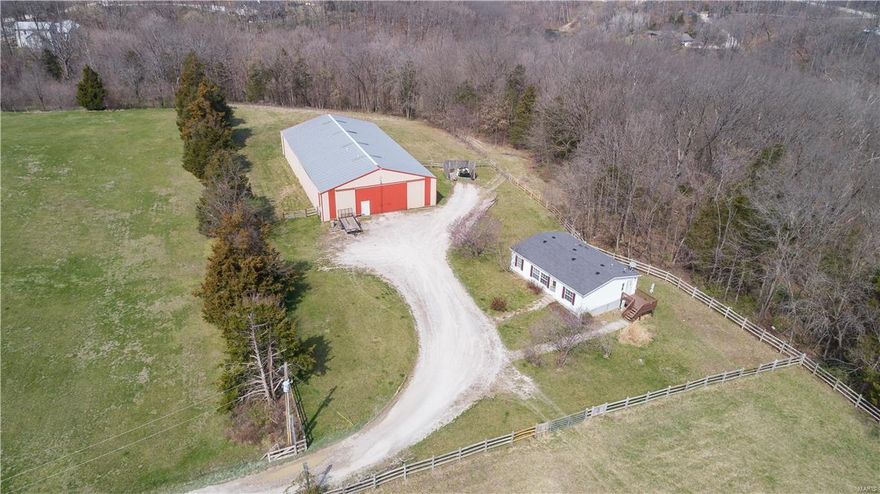 11+/- acres of Equestrian property. 2 pastures with slip board fencing, horse barn and double wide mobile home with vaulted ceiling and open floor plan.  The 55x100 horse barn features a tack room, observation room, 1/2 bath & feed room all with baseboard heating, 3-12x12 stalls, wash stall w/heat light, hot & cold h2o & fiberglass walls and an indoor riding arena. The mobile home has 3 bedrooms, 2 full baths, kitchen and living area. Taxes will be calculated after closing by St. Charles county  Great location to build your dream home. Part of a 41 acre parcel, all subdividing is subject to St. Charles County and all governing authorities. Home, 2 barns and additional 39+/- acres is also available for sale, MLS#17023080.