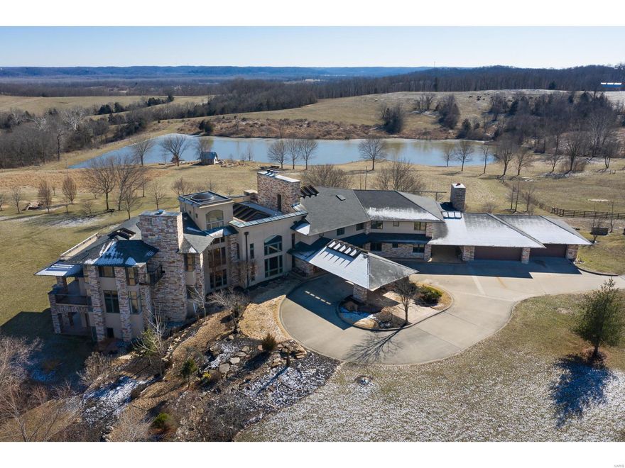 Spectacular residence in the "heart of wine country," with stunning views of 69+ acres, rolling hills, a sparkling lake, & an 1850's cabin! Breathtaking vistas make this 15,000+sq. ft. prairie style home an ideal retreat. Built in 2001, this home has an open floor plan that takes advantage of the outdoors with soaring ceilings, floor to ceiling windows, skylights, & many french doors leading to an expansive terrace. This home is an entertainer's dream! The inviting kitchen has a center island with granite countertop, top of the line appliances, & an adjacent hearth room with fireplace. The 1st floor master has a luxurious bath with walk in shower & 2 walk in closets. 2nd floor master has a lovely stone fireplace, vaulted ceiling & private bath. Another 2nd floor area has 4 BR & 2 full baths. Enjoy the huge lower level with family room, fireplace, exercise room, & ample storage. 1st floor laundry & storage rooms, 4 car garage, in ground pool. Property is in a Trust & offered "as is." Additional Rooms: Mud Room
