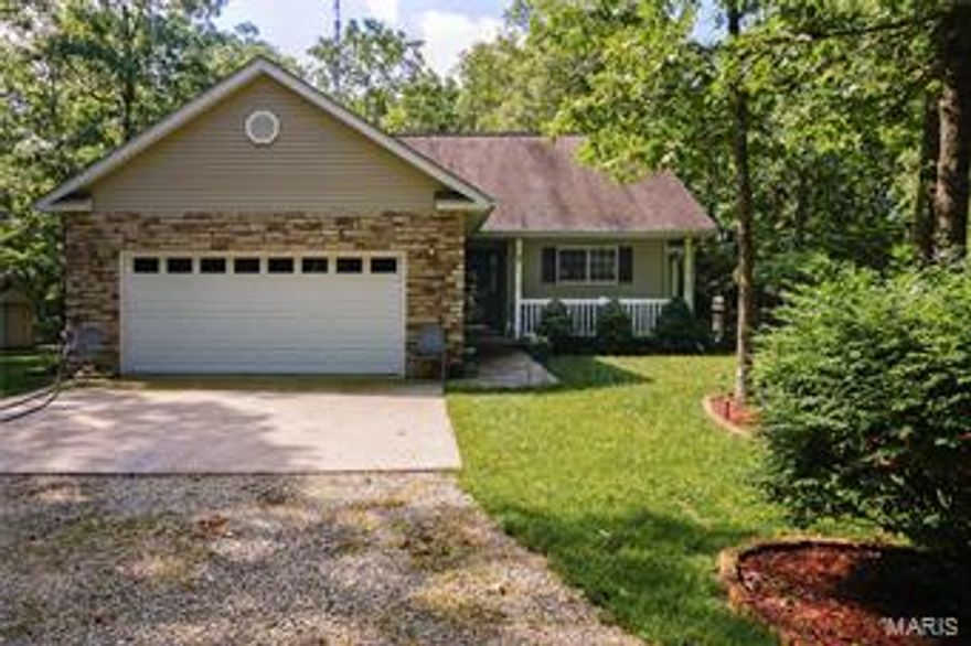 This home is absolutely adorable!  The setting is peaceful and the lot is beautifully landscaped with lots of shrubs, flowers and dogwood trees!  It has a cute covered porch, a nice deck off the back and a 2 car garage.   The interior is just as lovely as the exterior and offers over 1,300 m/l square feet with 3 bedrooms and 2 baths.  The living room has beautiful laminate floors and a gas fireplace.  The kitchen has an eat-in breakfast area, laminate flooring, lots of cabinet and counter space and a small pantry.  The butcher block island in the kitchen along with all the appliances will stay with the home.  The basement is partially finished with a family room and walks out to the back yard.  The home sits on 4.52 m/l acres and will include the house generator and portable shed.  This home has been meticulously maintained and is just exquisite inside and out!