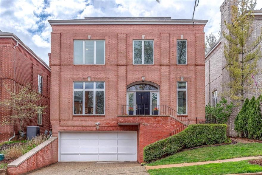 Stunning and sophisticated Clayton townhome just steps away from one of the ten most beautiful streets in the country--Wydown Boulevard. An amazing open floor plan, has an oversized great room w/marble surround gas fireplace, and offers tons of flexibility for entertaining and everyday living. The residence has 10 ft ceilings, a separate dining room, main floor study with fireplace, wood floors throughout the main and upper level, recessed lighting and a private yard with beautiful terrace. The crisp white kitchen opens to the great room with large windows letting in an abundance of light. The Master suite is huge with tall ceilings, luxurious bath, and great closet space. 2 additional bedrooms, another bath, and  laundry room complete the upstairs. There is a finished lower level w/half bath, a 3 car garage and a dumbwaiter to help lift groceries to the main floor!  Great location w/in walking distance to Forest Park, schools, restaurants and shops and all that Clayton has to offer!