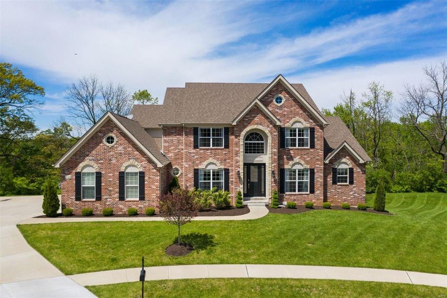 Exceptional Colonial brick and stone home situated on a private cul-de-sac street boasts 4 beds, 3.5 baths w/ beautiful crown molding and custom finishes throughout.  2 story entry opens to formal D/R and handsome office w/ custom millwork.  D/R features tray ceiling, chair rail and wainscoting.  Great Room boasts 18ft ceiling, gas fp w/ stone surround, 2 chandeliers, and offers look out to private backyard.  Luxury Gourmet Kitchen w/ SS appliances and granite countertops, custom cabinetry w/ soft close drawers, butler pantry, and large center island. Breakfast room w/ access to patio surrounded by mature trees. Master Bedroom suite features coffered ceiling, large bay window, his/hers professionally organized closets. Master bath w/ large shower, soaking tub, and his/hers vanities. Upstairs includes 3 bedrooms w/ one en-suite, a full hall bath w/ double sink vanity, and a bonus room. Main floor laundry, 3 car side - entry garage, sprinkler system, and concrete patio off walk-out.