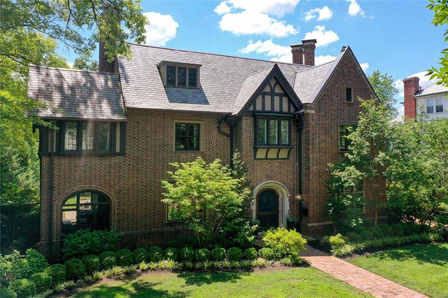 This stately Tudor Revival home is nestled in the heart of Clayton's most desirable neighborhood. Built in 1917, it has undergone a major renovation while preserving architectural details throughout. It seamlessly blends historic charm w/ modern updates, making the home a perfect blend of elegance and modern convenience. The 1st fl features 10ft ceilings, wood floors, original millwork and crown molding. The entry hall, w/ a wide, grand staircase, runs the depth of the house. You'll love the custom eat-in kitchen which opens to a large family rm w/ doors leading to the back patio and yard. An elegant living rm adjoins a 3-season sunroom w/ access to the patio and yard. The primary suite is located on the 2nd level w/ double vanities, soaker tub, glass shower, and large walk-in closet. 2 addtl en-suite bedrooms and laundry rm are also located on 2nd level. The 3rd fl has 2 guest rms & a full bth. Minutes to Forest Park, downtown Clayton, top rated public and private schools, and Wash U. Additional Rooms: Mud Room