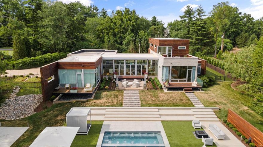 Privacy and luxury abound in this magnificent modern masterpiece. Wall of windows facing the grounds, gorgeous floors & 10+ft ceilings welcome you to this stunning compound. The kitchen, dining, & great room offer impressive views of the new pool/spa & guest house, along with both front and back patios, the ultimate in indoor & outdoor living. The kitchen & butler's pantry are incredible in design and functionality. The primary suite is a serene space with expansive closets, bath, & private deck overlooking the 1.9 acreage. Also on the main floor is a guest room that doubles as a family room. Upstairs are 2 bdrms, 2 baths & a den with built in desks, & a lovely deck. The lower level offers a gym, bath & recreation room you can design to suit your needs. Wow guests with a pool house with chef's kitchen, 2 ensuite bdrms, pool bath, family room, & game room. The main house offers 5700+ square feet while the pool house offers 1700+ - luxurious everyday living in a unique, special getaway. Additional Rooms: Mud Room