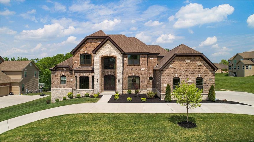 Beautifully crafted 2 year old build in the Belle Maison neighborhood! This home boasts incredible upgrades and impressive finishes  including beautiful wood flooring throughout for an open feel, Iron Lion 72" front door, and crystal light fixtures. First floor offers a grand entry, open two story living room with beautiful views of the backyard and gas fireplace, 10' ceilings, master suite with his/her walk in closets and spa bathroom, top of the line eat in gourmet kitchen featuring Wolf, SubZero, Vent-A-Hood, ASKO appliances and walk in pantry, dining room with butlers pantry, and family room with Linear fireplace! Second floor includes 3 en suite bedrooms and bonus space for potential office or sitting area. The fully loaded walkout 1900 sq ft lower level will host all of your favorite people in style with an impressive full kitchen, granite and ss, full bar, media room, roughed in bedroom & bathroom! Large lot with walk out patio and deck, 3 car side entry garage! Stunning!!