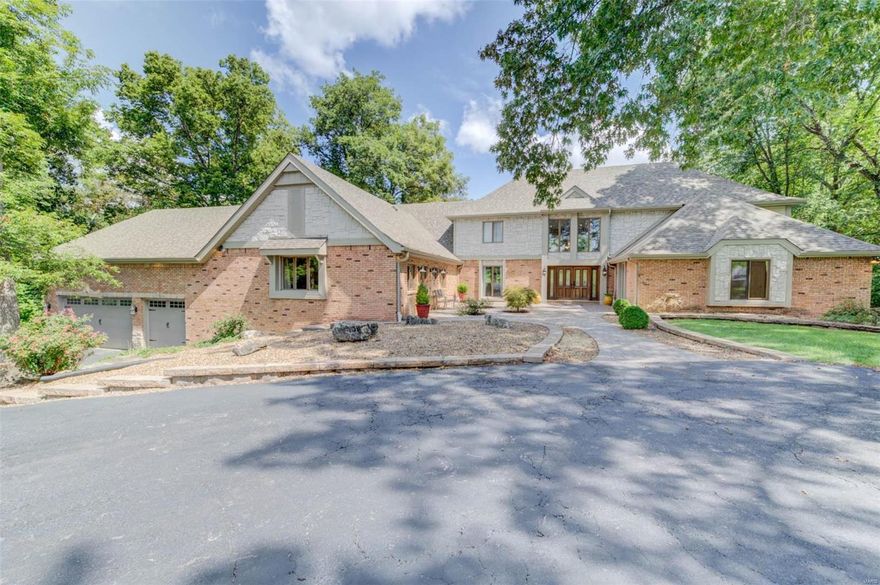 WATERFRONT Estate on private 1.8 ACRES. SPACIOUS 1.5 story residence w/open floorplan & gorgeous updates. Majestic 2 story entry w/views of iron spindled stairway & balcony, elegant sunken living room & the scenic wooded lot beyond. Lots of beautiful WOOD & marble floors. 5 bedrooms, 2 up & 3 on the main level w/a possible master on both levels. The impressive kitchen & hearth room combo w/soaring vaults must be seen to be appreciated! Formal dining room, huge family room & upper-level theatre room. Walkout L/L is beautifully finished offering large rec room w/fireplace, wet bar & exercise room. Screened in porch & 2 levels of decking overlook attractive inground POOL w/pool house & wooded lot that leads to your private DOCK on the large lake. LSLCA Amenities. Did I mention the tandem garage that could house 5 or 6 vehicles? Association fees are $150/yr. to Timberlaine Trails and $600/yr. to LSL Community Association. This home is truly one-of-a-kind!