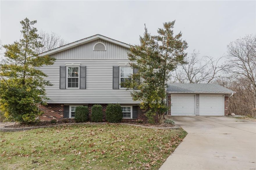 Lovely split foyer featuring 3 bedrooms and 3 full baths in the popular Wildflower subdivision. This home sits at the end of a cul-de-sac street and backs up to acres of common ground and trees. This home offers over 2,000 sq ft of living space. The updated kitchen offers an abundance of cabinets and counter space, plus stainless steel appliances, track lighting and ceramic tile floor. You will appreciate that this home has a newer architectural shingle roof, hot water heater, furnace and AC.  The finished walk-out lower level has a large family room with a brick wood burning fireplace, full bath and bonus room for a potential fourth bedroom or office. Breakfast room leads out to a large 28 x 12 composite deck great for entertaining or enjoying the quite view of the common ground. AAA Parkway School District. Located between the New Maryland Heights Rec Plex and the 2,000 acres Creve Coeur Park and Lake.