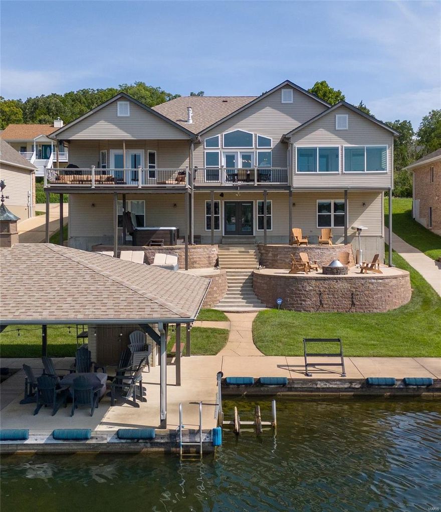 Experience luxury living in this magnificent premium lakefront ranch. This meticulously updated home offers 4 beds & 3 baths. Enjoy breathtaking lake views from your private boathouse & expansive backyard. Inside, custom amenities abound, featuring beautiful flrs, upgraded light fixtures & recessed lighting. Vaulted great room with fireplace & wall of windows seamlessly connects you to endless water views. The chef’s kitchen is a dream with large island, quartz countertops, farmhouse sink, premier ss appliances & custom 42” cabinets with soft-close doors. Retreat to the spacious primary suite, complete with coffered ceiling, private FP & luxurious bath with walk-in shower & quartz double vanity. Walk-out lower level includes 27' rec room, 3rd FP, 2 large bedrooms (both with lake views), multipurpose sleeping area, full bath & wet bar. Enjoy outdoor entertaining on custom decks & sundeck. Add'l features: stunning hardscape, circle drive, oversized garage, composite decking & EV charger. Additional Rooms: Mud Room, Sun Room