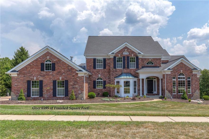 Exceptional brick & stone crafted 1.5 Sty in prestigious Wildhorse! Open floor plan features extensive millwork, arched entryways & gleaming wood floors that flow throughout the main floor.  Dramatic 2-sty marble foyer leads to private study, elegant dining room & stunning great room with marble fireplace, wet bar & 2-sty wall of windows overlooking infinity pool & tree-lined grounds. State-of-the-art kitchen adjoins light-filled breakfast room & hearth room with dimensional ceiling & stone fireplace. Coffered master bedroom suite with luxury bath with Jacuzzi offers a relaxing retreat. Front & rear staircases access 3 additional bedrooms, 1 with ensuite bath & 2 with Jack n’ Jill bath, plus loft sitting room. Walk-out Lower Level includes recreation room with entertainment center, game room, workout room, 2nd kitchen, 5th bedroom & full bath. Situated on a .58 acre lot with pool & 3-car garage. Neighborhood community with 2 swimming pools, tennis, walking trails & wildlife preserves.