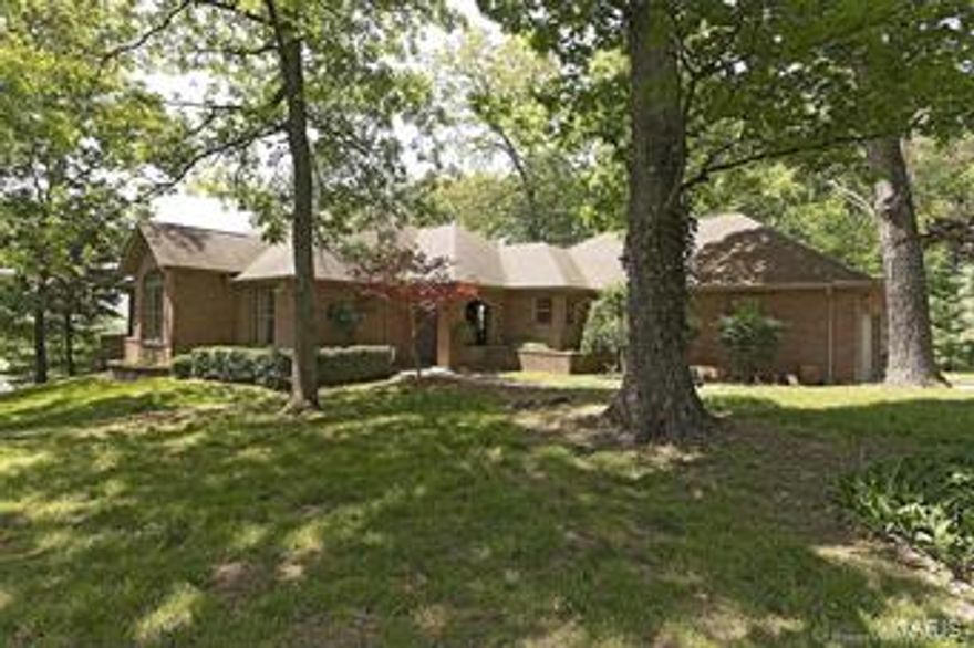 Smart buyers know you don't want the most expensive house in the neighborhood.  You want the least.  Well here it is!!!  Get to live in prestigious Touchdown Estates without paying Touchdown prices.  This home is a traditional style with a flair of contemporary.  Sunken living room with stone fireplace, very open floor plan leading into the kitchen & dining room.  Roomy kitchen w/lots of counter space & pantry.  Great master suite with 2nd fireplace for those romantic nights.  Lots of windows overlooking gorgeous wooded 2 acre lot.  All brick, fresh paint, new flooring, move in ready.