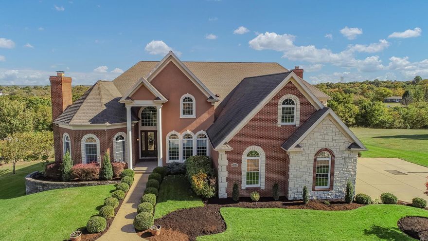 Fabulous custom home with pool situated on 1.35 acre lot backing to woods! This exceptional home begins with the circle driveway leading guests into the 2 story entrance with a sweeping grand staircase.  Situated to the left is the executive office which is richly appointed. To the right is the formal dining room with lighted tray ceiling.  Ahead is the great room with the most gorgeous view through the Palladian windows!  Main floor master suite features lighted tray ceiling, sitting room, luxury bath, and private deck.  The gourmet kitchen, breakfast room, and hearth room are the heart of this home with perfect gathering areas.  The second ensuite bedroom is also on main level.  The second floor features loft area, third ensuite bedroom, along with bedrooms 4 & 5 with shared bath.  The atrium lower level "lodge" has numerous gathering areas, along with walk-in gun safe, theatre room, bar area, and an additional bedroom.  Outside you will find the gorgeous pool area with outdoor room!