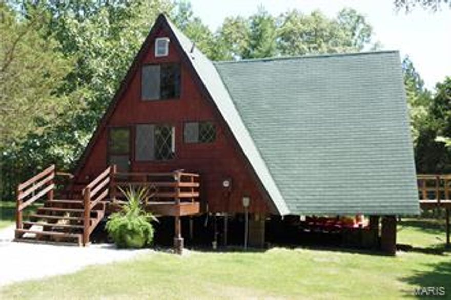 This unique property in a park like setting only 30 minutes from St. Louis and St. Charles subdivisions has had many recent updates making it move in ready! 2017- NEW 1000 GALLON SEPTIC TANK, NEW MASTER BEDROOM DECK, FRESHLY STAINED EXTERIOR. 2016- NEW NEUTRAL CARPETING UPPER LEVEL, NEW EATON 200 AMP ELECTRIC PANEL, NEW REEM WATER HEATER AND NEW AIR CONDITION FAN MOTOR. 2015- REMODELED KITCHEN WITH NEW WHITE CABINETS AND GRANITE COUNTERTOPS as well as NEW LIGHTING THROUGHOUT ENTIRE CHALET. 2012- NEW WRAP AROUND REAR DECK. 2011 -NEW NEUTRAL CARPETING LOWER LEVEL, NEW BATHROOM SINK AND TOILET. 2010- NEW ROOF! 2009 NEW ENTRANCE DECK. Don't let the season slip away! Great part time residence with a lot of community amenities and multiple lake access and outdoor activities. Can sleep 6-8 people comfortably. It is waiting for the right family to make it their own.