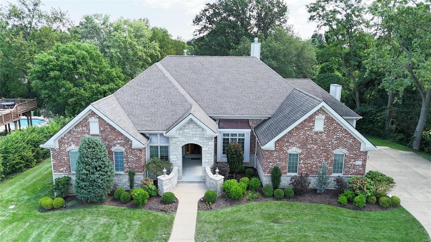 Beautiful 12-yr-old 5 BR, 4.5 BA custom-built, single-owner home in the highly rated Ladue School District. The atrium ranch layout boasts vaulted ceilings, large atrium windows, and a grand staircase connecting the upper and lower levels. The professionally decorated main floor features an open kitchen with granite counters, high-end appliances, wood floors, a hearth room with surround sound, and 1 of 3 gas fireplaces. Two ensuite BRs and a large office complete the first floor. The walkout LL includes 2 large BRs, a full bath, bar, kitchenette, and 2 large storage areas with set-up for a wine cellar. Enjoy outdoor entertaining on the real-wood deck overlooking a large, flat, fenced yard. Additional features - generous 3 car garage w/ EV charging station, circular drive, custom window treatments, and abundant natural light throughout. This home perfectly combines sophistication, comfort, and functionality yet, its only minutes to Ladue, Clayton and West County. Additional Rooms: Mud Room, Wine Cellar