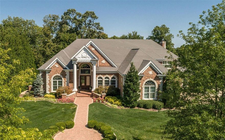 Fantastic brick & stone 5 bedroom 1 1/2 Story situated on a 1.25 acre lot. 4 car. Grand 30' long 2 story entry with curved staircase & balcony. Den with custom wet bar & moldings. Dining room with coffered ceilings & indirect lighting. Spacious great room with window wall, fireplace flanked by custom built ins all overlooked from balconies above. Magnificent kitchen with center island, 48" range with custom hood plus a built in oven. Ornate cabinetry with lots of moldings & under cabinet lighting. Granite tops and backsplash. Breakfast and hearth room both have bays. Huge master with coffered ceilings, crown, and indirect lighting. 2 closets. Custom bath with glass shower, jet tub, ornate cabinetry and ceilings lines. Rear stairs off kitchen to upstairs family room & 4 spacious bedrooms. Lots of ornate moldings, arched doors & windows. Plantation shutters in all bedrooms. Gorgeous aggregate patio with pond, waterfall, fire pit & mood lighting. Great for entertaining.