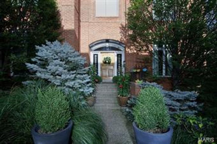 Find sophisticated urban living within blocks of the Clayton business district.  Truly a unique opportunity, this residence has been beautifully and elegantly updated within the last few years.  Every space has been thoughtfully conceived.  You will discover a two year old gourmet kitchen customized for entertaining with designer appliances including double ovens and two dishwashers.  The living room is accented with a dramatic fireplace surround and mantle.  Oversized windows infuse light to every level of living area. The kitchen opens to an intimate hearth room and a private deck.    The windowed lower level walks out to the terrace set within a lush and secluded garden.  The fabulous master suite includes a fireplace, 3 organized wall closets plus a huge walk-in closet and luxurious bath.  At every turn, the home offers impressive attention to detail.