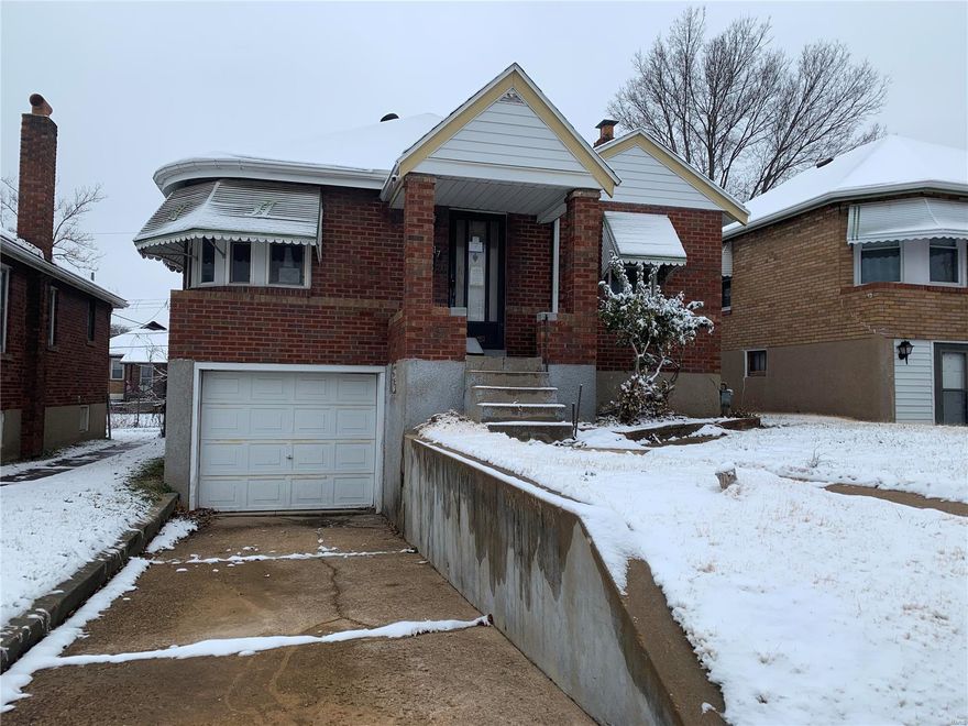 Call all investors! Gutted rehab property that is ready for your project. Outstanding brick bungalow with great potential: 2 bedrooms, formal living room, 1 bath and large enclosed rear porch. Special features include: brand new plumbing and electric work done by licensed contractors, tuck under 1 car garage, some wood floors, rounded living room windows, arched doorways, newer windows, driveway, stamped concrete side walk, glass block windows and a shed in the back yard! It could be an awesome home when it is done. Must see!