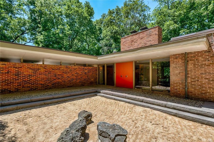 Located on 3 private acres in Ladue is this Bernoudy-design contemporary masterpiece. The centerpiece of the home is an open Living Room & Dining room with vaulted ceilings, coved lighting, built-in bookcases, a fireplace & an expanse of windows that look onto a wooded lot. The kitchen is bright & features granite counters, double ovens, stainless steel refrigerator & skylights. The master bedroom suite is special with a dressing room that would satisfy anyone with a need for plenty of closet space. The master bath has been renovated with a soaking tub, walk-in shower, custom finishes & marble tile. Adjoining the master bedroom is another area with an expanse of closets & another full bath. There is a cozy den with a fireplace on the main floor, laundry & office. The LL has a full wall of windows & sliding doors that lead to a terrace. There is a large recreation room with a wood-burning fireplace, 3 more bedrooms, 2 baths, new kitchenette, storage & a 2nd laundry.
