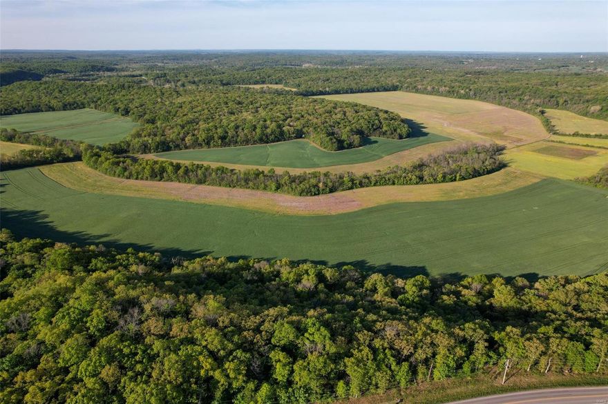 Sitting less than two miles from St. Clair, this farm boasts 1.25 miles of road frontage on Highway TT, including over one mile where the farm lies on both sides of the Highway. The property lies on both sides of Moselle Road for approximately .15 miles and has nearly half of a mile of frontage on both sides of Mill Hill Road. 

Currently, 330 acres of the farm are being leased for crop production. 

The timber stand is marketable and gives you more of a State Park feel than a private farm.

Cove Spring is located on the property pushing live water throughout the farm.  The rock outcroppings in the area around the spring are incredible between Highway TT and the bottom ground.  In addition to the spring, Cove Creek meanders through the property over a mile and eventually feeds into the Meramec River.  

This may be one of the last opportunities to acquire a tract this size in Franklin County.