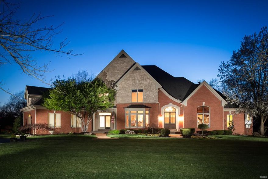 This magnificent Johnson built custom 1.5 story residence is located in a gated community in the heart of Frontenac! The timeless design features a stunning 3 story grand foyer & has many dramatic surprises!   Luxurious main flr master suite w/ coffered ceilings, crown molding, plantation shutters & walls of windows. Elegant spacious master bath & oversized walk/in closet.  Lovely Din Rm w/ bay, music rm w/ marble flooring & paneled library/den  w /frpl.  Outstanding Kit/hearth rm w/frpl & blt-ins --opens to 3 -Season room & newer Tigerwood deck.  2 spacious en-suite bdrms on 2nd flr along w/ bonus rm w/ built-in work station. The LL finishes are as high quality as main flr.  Lower Level boasts a dramatic 3 story Grt Rm flanked by windows & frpl, media room, /recreational room & mini kitchen. There is also a 4th luxury en suite bedrm w views of lush lot. Private acre lot w/ space for a pool.  3 car oversized garage. Brand new carpet & neutral paint thruout.  What more could you want?