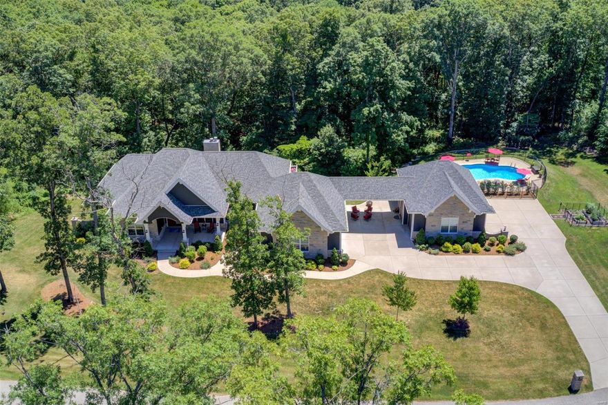 Come and tour this absolutely stunning home on 5+ beautiful acres in the Defiance area.  Close to wineries, bike trails, fishing and amazing hunting.  This 4800+ Sq Ft home boasts 10-foot ceilings on the main level and 9-foot in the lower, 2 wood burning fireplaces, 4 huge bedrooms, 3 1/2 baths, gourmet kitchen with Cambria quartz, top of the line appliances, and walk in pantry.  In the walk out basement, you will enjoy a full bar, huge wine cellar, and all the room you will need for entertaining.  For your outdoor get-togethers, a magnificent deck runs the length of the house and provides amazing views and welcome privacy. And nothing refreshes quite like the large built-in, heated, saltwater pool, with its own restroom facilities. Parking for 5 cars in two oversized garages round out this home perfectly.  You won’t find a better place to raise your family, host your friends, or just to take the edge off of a stressful day. This is the home you have been waiting for. Additional Rooms: Wine Cellar