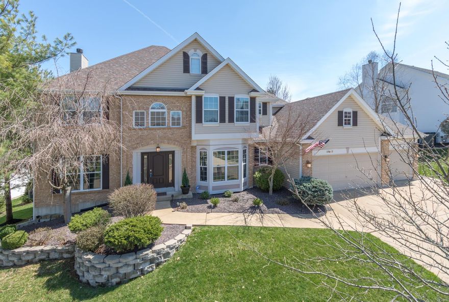 Beautifully maintained and updated throughout.  1st floor has a large bedroom with full bath for guests or anyone.  Main floor laundry and the kitchen has solid surface counters, kitchen desk, pantry, gas range,with large work spaces and 42" staggered cabinetry.  The 2nd floor contains the lavish Master en suite with coffered ceiling and bay window.  Master bath is very roomy with granite counters and beautiful updates.  There are 3 additional bedrooms, 2 have a Jack 'n' Jill bath and the 3rd is another suite. The professionally finished LL is equipped with another bedroom, bathroom and a fully stocked kitchen with SS appliances an eat at bar with granite counters.  Still plenty of room for a rec room large enough to accommodate the pool table and games.  In addition there is a private area for an exercise room and an office.  Storage is quite large and has built in shelves.  The lower level is walk out and has engineered wood floors throughout.