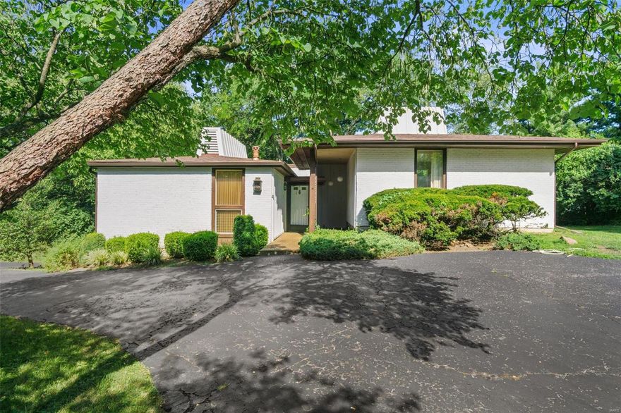 Unique ranch home in Takara neighborhood in Town & Country.  Ideal and desirable split ranch floorplan with three bedrooms, two full and one half bath.  The great room features a beautiful beamed ceiling, wood floors, gas fireplace and floor to ceiling windows that provide lots of natural light!  Separate dining room.  Master bedroom with many large windows, full bath and walk-in closet.  The two additional large bedrooms share a jack-n-jill bath.  Zoned HVAC. Partially finished lower level.  Huge side entry tuck-under garage.  Circular drive. Private large lot at the end of the street backs to trees!  This home interior must be seen for its "ahead of its time" features!