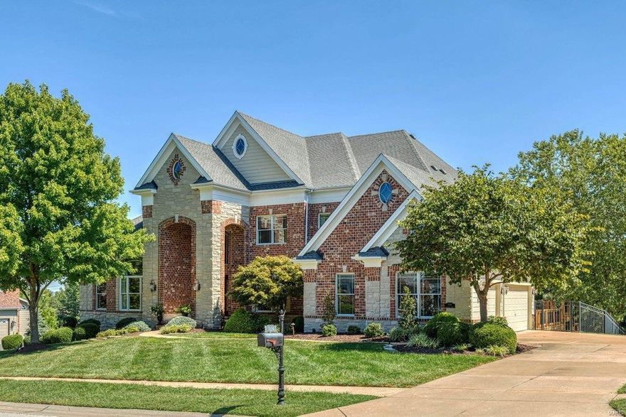 Beautifully designed brick & stone 1.5 Sty from award-winning Taylor-Morley Homes. Impressive 2-sty entrance leads to marble foyer with floating staircase that overlooks stunning great room with dramatic wall of windows & marble fireplace flanked by mirrored display cases. A framed tray ceiling & detailed millwork set the tone for the formal dining room. Designer kitchen with 42” maple cabinetry, granite countertops & 7’ center island adjoins breakfast room with octagonal ceiling & convenient planning center & vaulted hearth room with floor-to-ceiling stone fireplace. Coffered master bedroom suite offers a relaxing retreat with luxury bath with jetted tub & sitting room with adjacent study. Front & rear staircases access 3 additional ensuite bedrooms. Lower Level includes recreation room with see-through fireplace & wet bar, game room, media room, family room, 5th bedroom & full bath. Situated on a 1+-ac lot with bilevel deck, patio & resort style pool surrounded by landscaped gardens.