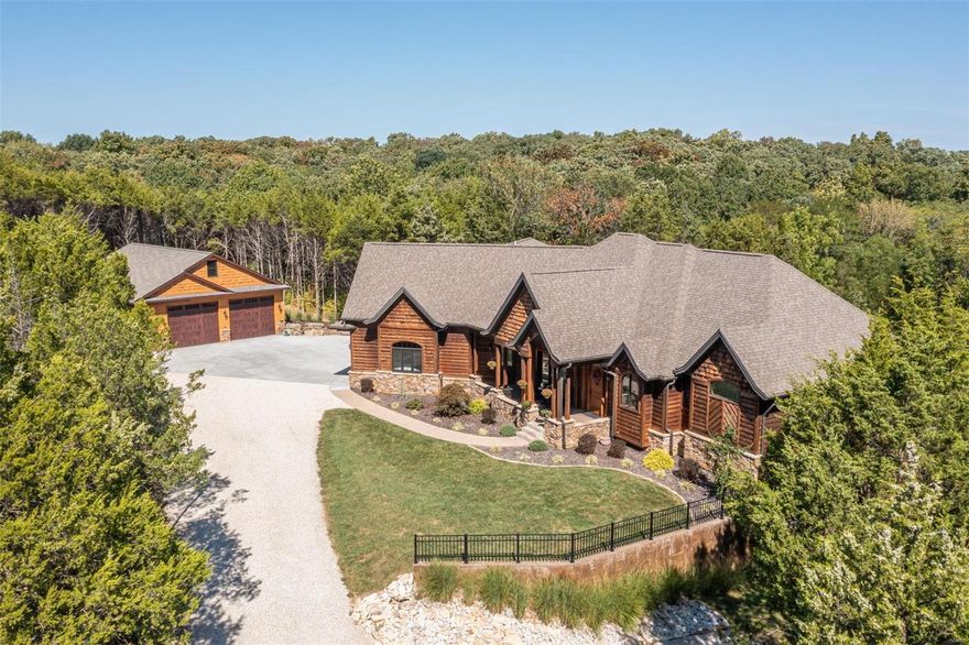 Escape everyday to this grand 5 bedroom 4.5 bath ranch home with custom amenities throughout. Cathedral wood ceilings, atrium doors & windows make this an inviting & sun lit space with hardwood flooring, 2 gas fireplaces,  great room, 10 ft ceilings, hearth room, custom kitchen with granite counter tops, center island, breakfast bar, buffet areas, walk in pantry, bar & coffee bar, breakfast room & separate dining, office & covered back deck for entertaining. Divine master bdrm suite, walk in shower, double sinks & amazing walk in closet. 2 additional bdrms with Jack & Jill bath. Main floor laundry, half bath, upper level living qtrs has living room, kitchen, bdrm & balcony. Lower level is a massive rec room for TV watching, bar area, pool table room, 5th bedroom, full bath, unfinished storage & more. Walk out to the covered patio & private back yard. Over 7500 sq ft of living space with inviting covered front porch, newer 35x48  detached garage, manicured lawn & landscaping. Beautiful!